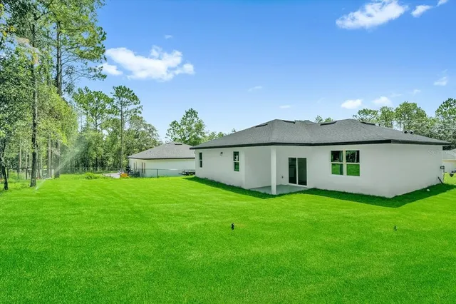 an aerial view of residential houses with outdoor space and street view