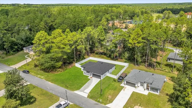 an aerial view of a house with a backyard