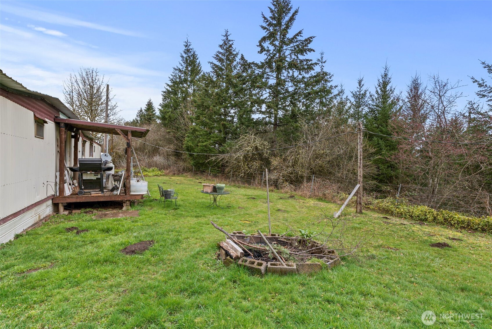 535-543 Knowles Road Winlock, WA 98596 - Photo 30 of 32 a backyard of a house with lots of green space and trampoline
