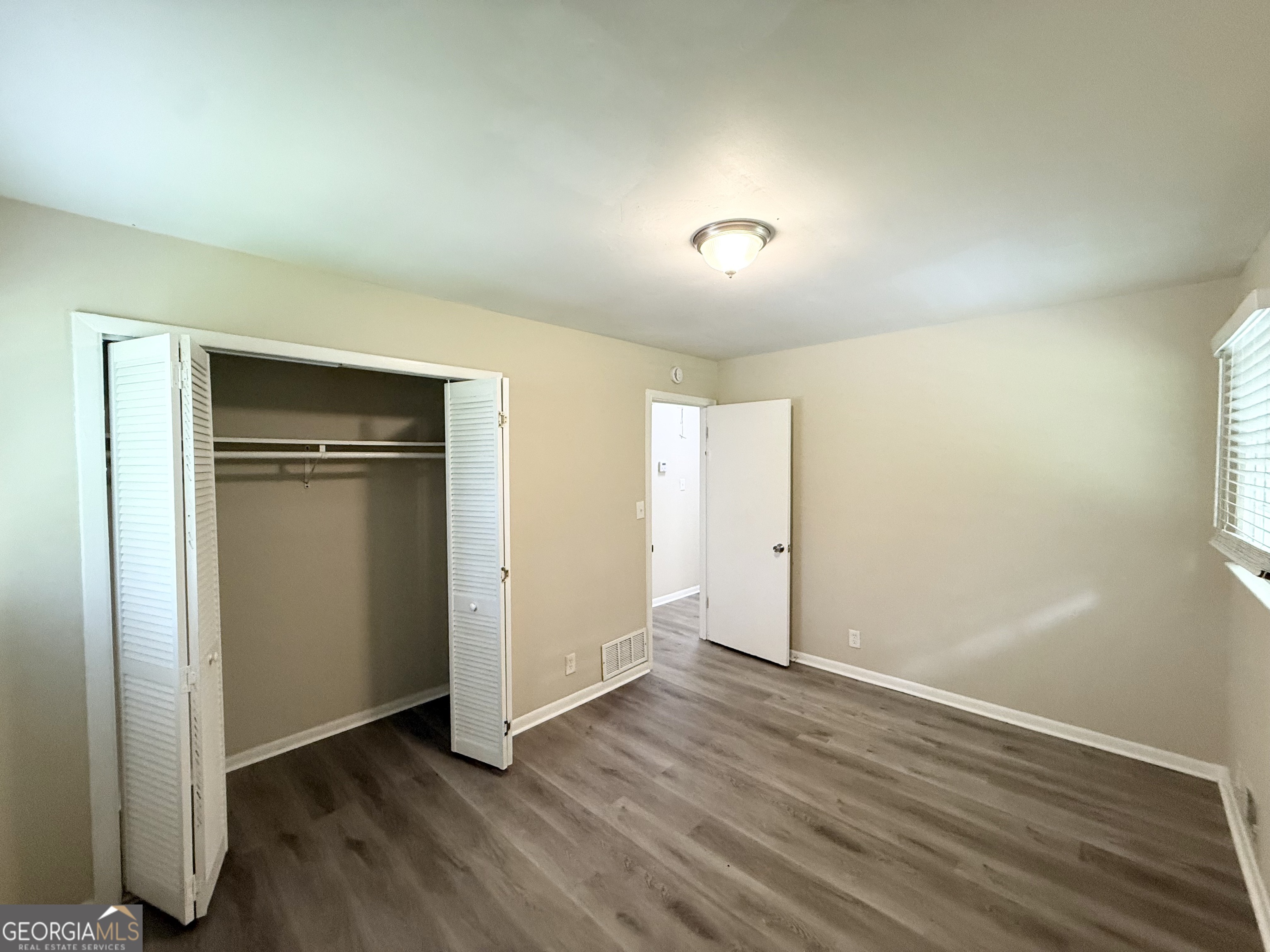 2782 Ocean Valley Road Atlanta, GA 30349 - Photo 14 of 27 an empty room with wooden floor and closet