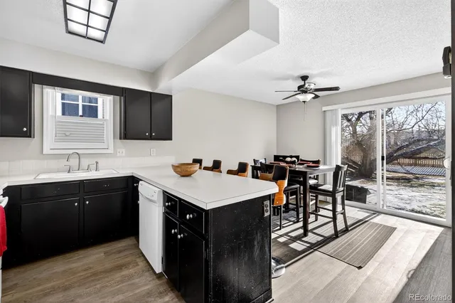 a kitchen with a table chairs sink and cabinets
