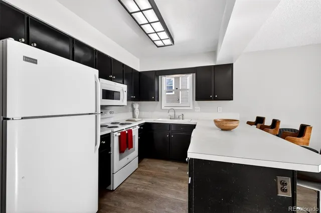 a kitchen with stainless steel appliances a refrigerator sink and microwave