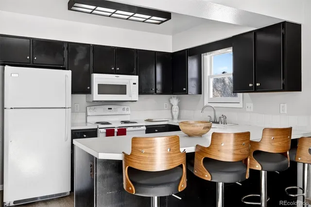 a kitchen with stainless steel appliances a stove a sink and a refrigerator