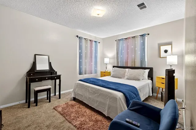 a bed room with a bed and a chair