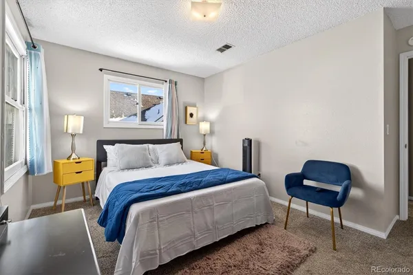 a bedroom with a bed and a chair