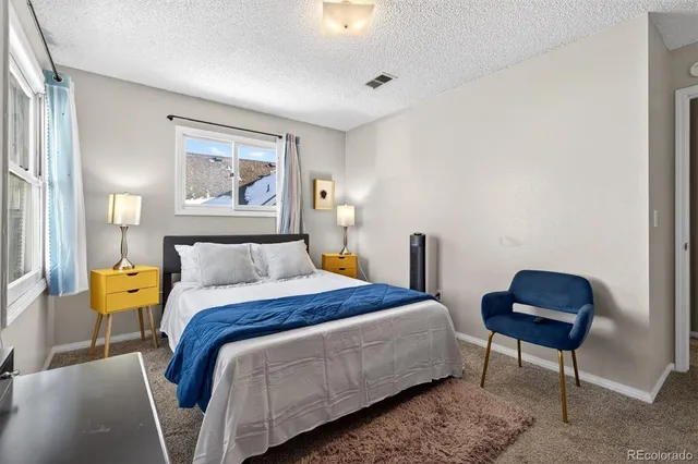 a bedroom with a bed and a chair