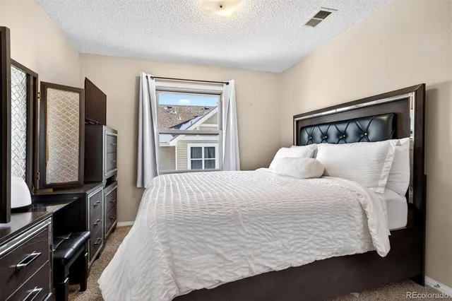 a bedroom with a balcony a bed and a flat screen tv