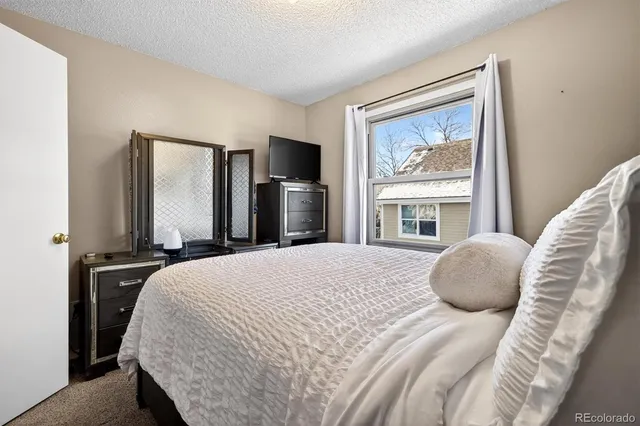 a bedroom with a large bed and a flat screen tv