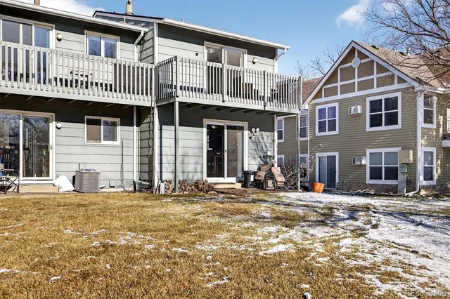 a front view of a house with large windows and a tree