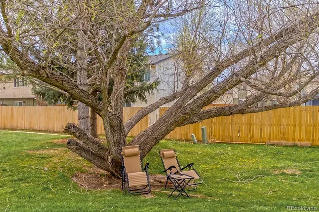 a backyard of a house with table and chairs