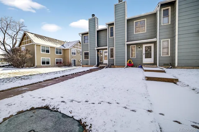 a view of a house with a snow on the road