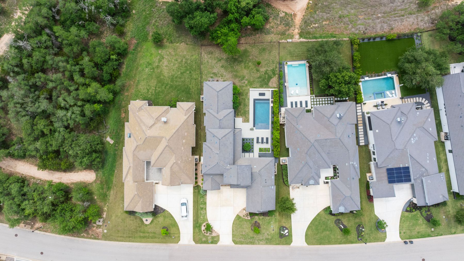 1106 Flint Ridge Trail Georgetown, TX 78628 - Photo 33 of 38 An aerial perspective reveals several neighboring residences, each featuring a private pool and well-maintained grounds.