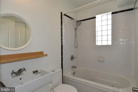 a bathroom with a bathtub a toilet and a sink