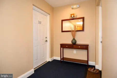 a view of a livingroom with wooden floor and a potted plant