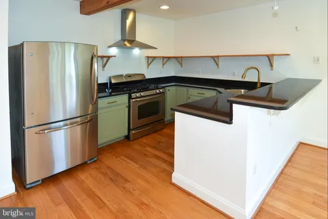 a kitchen with granite countertop a refrigerator and a stove