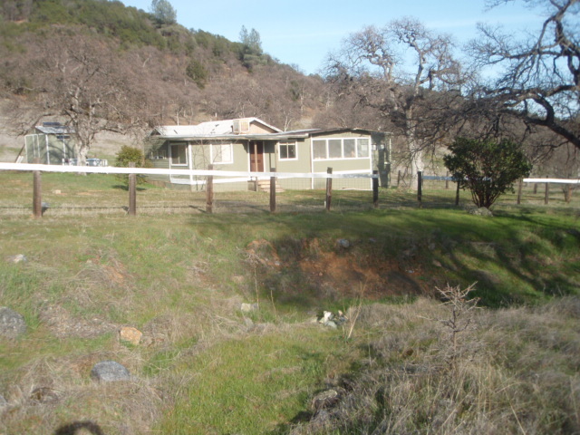 8768 Big Foot Road Igo, CA 96047 - Photo 16 of 41 a front view of a house with a yard