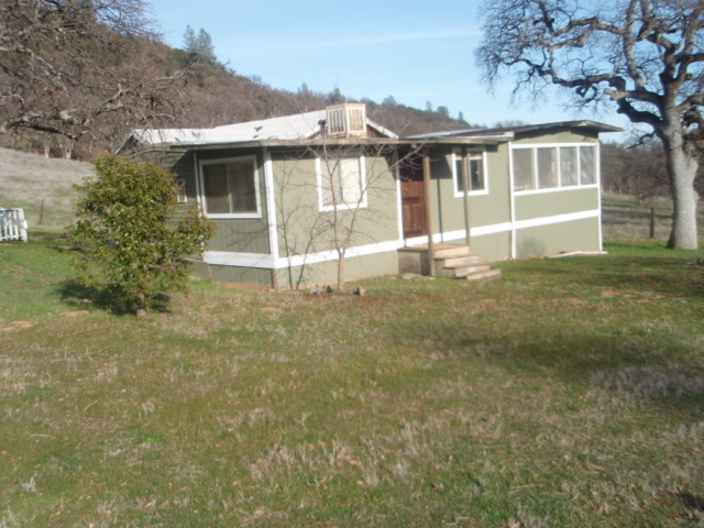 8768 Big Foot Road Igo, CA 96047 - Photo 17 of 41 a front view of a house with a yard