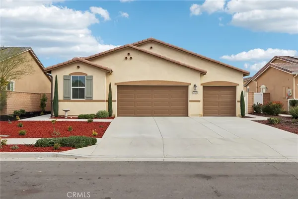 a front view of a house with yard and garage