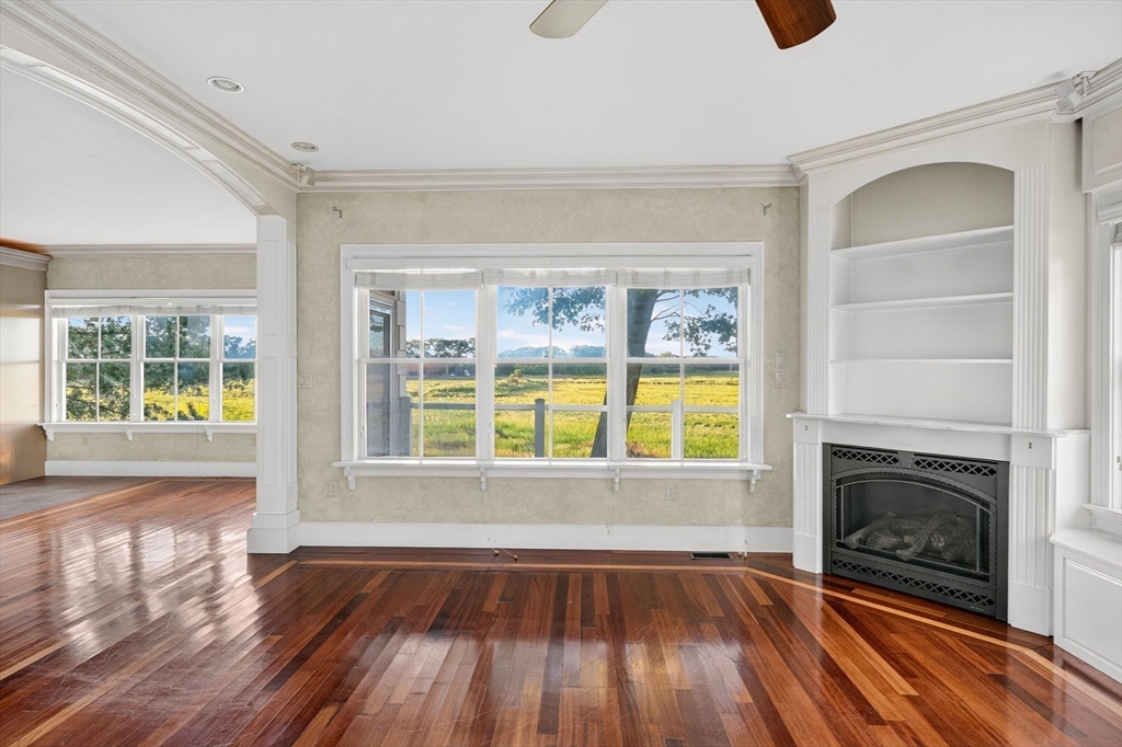 12 Quentin Street Milton, MA 02186 - Photo 12 of 41 a view of an empty room with wooden floor and a window