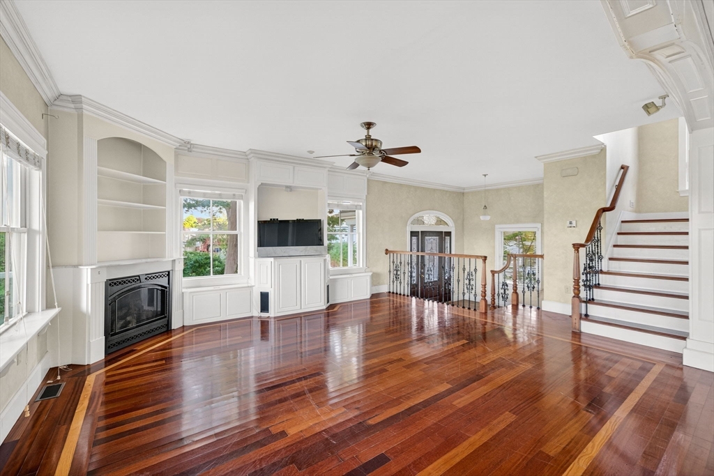 12 Quentin Street Milton, MA 02186 - Photo 14 of 41 a living room with furniture and a fireplace with kitchen view