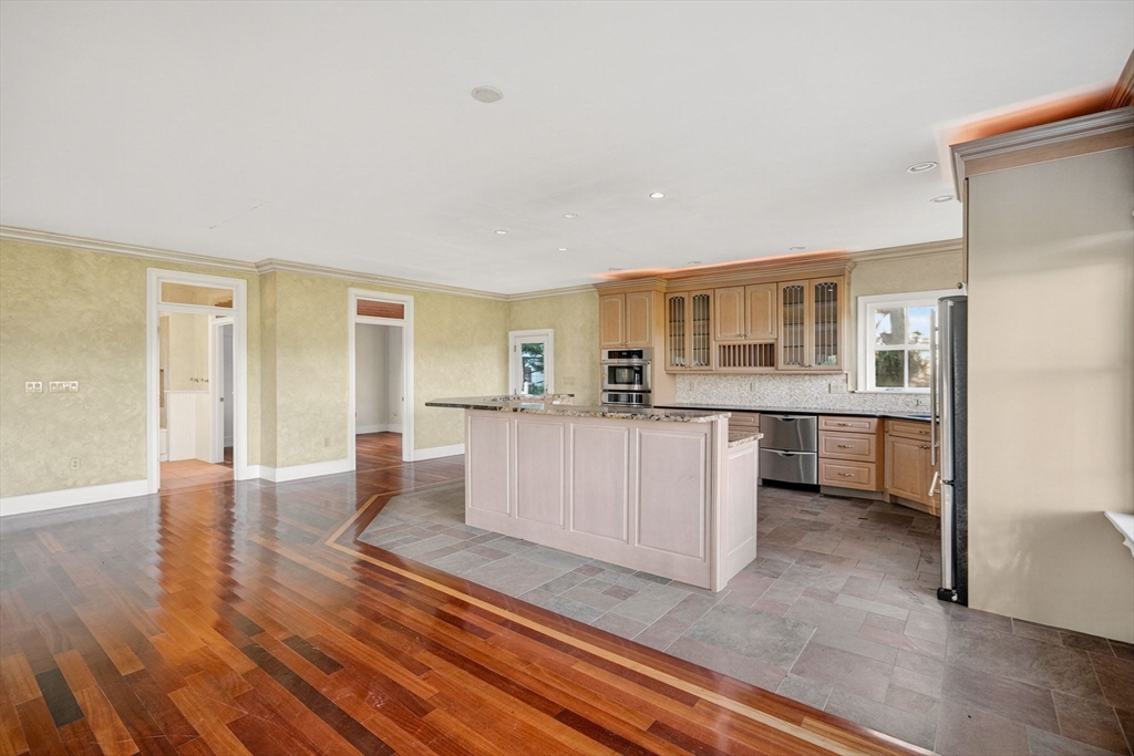 12 Quentin Street Milton, MA 02186 - Photo 18 of 41 a living room with furniture and a kitchen view