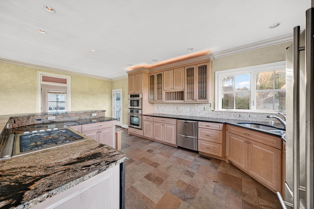 12 Quentin Street Milton, MA 02186 - Photo 19 of 41 a large kitchen with granite countertop a stove and a sink