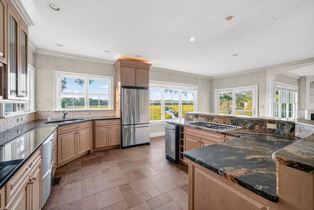 12 Quentin Street Milton, MA 02186 - Photo 21 of 41 a large kitchen with stainless steel appliances granite countertop a sink and a stove