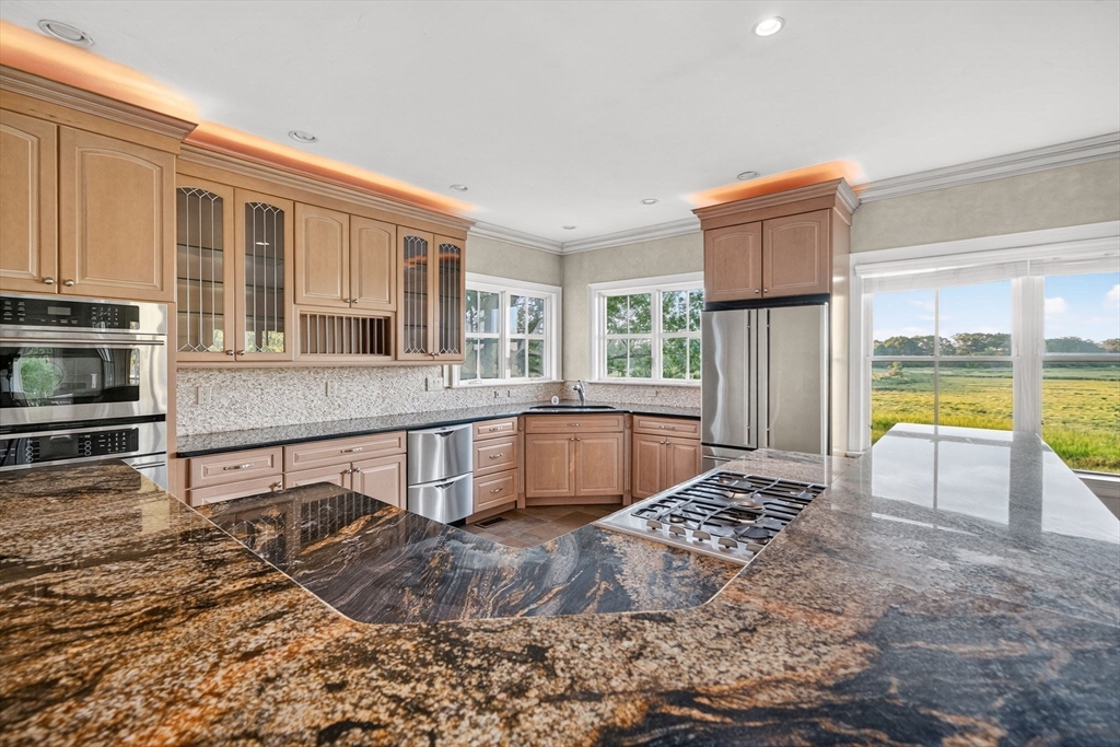 12 Quentin Street Milton, MA 02186 - Photo 22 of 41 a kitchen with stainless steel appliances granite countertop a stove a sink and a microwave