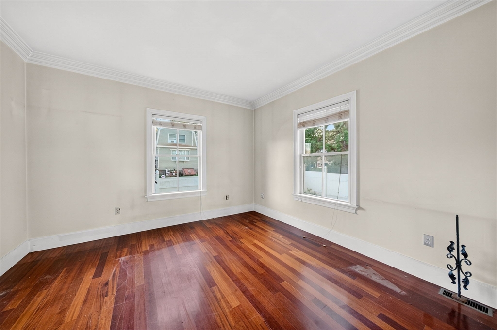 12 Quentin Street Milton, MA 02186 - Photo 26 of 41 a view of an empty room with wooden floor and a window
