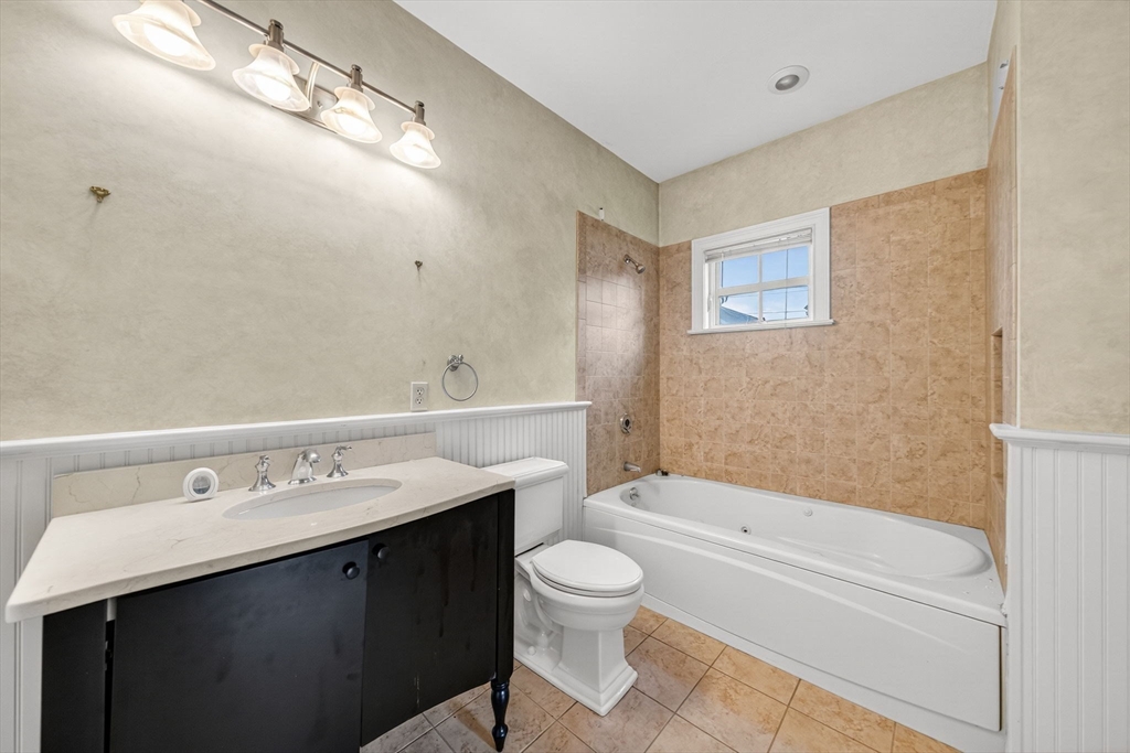 12 Quentin Street Milton, MA 02186 - Photo 29 of 41 a bathroom with a sink a toilet and shower