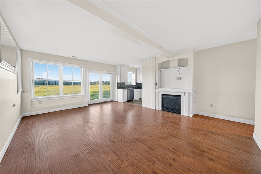 12 Quentin Street Milton, MA 02186 - Photo 33 of 41 a view of empty room with fireplace and wooden floor