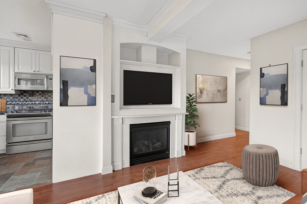 12 Quentin Street Milton, MA 02186 - Photo 34 of 41 a living room with furniture a flat screen tv and a fireplace