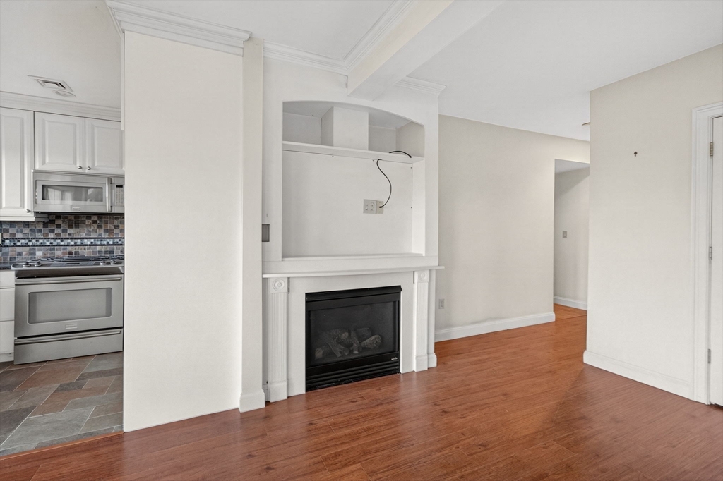 12 Quentin Street Milton, MA 02186 - Photo 35 of 41 a view of kitchen and empty room with wooden floor