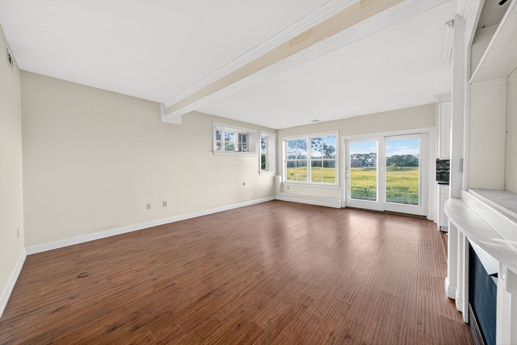12 Quentin Street Milton, MA 02186 - Photo 36 of 41 an empty room with wooden floor and windows