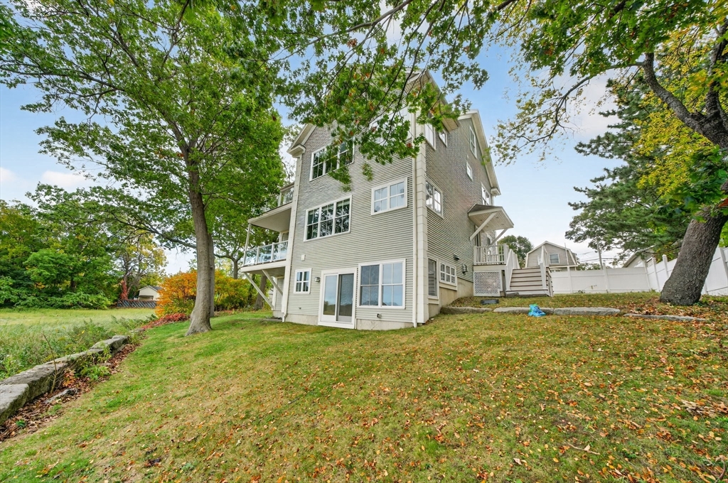 12 Quentin Street Milton, MA 02186 - Photo 4 of 41 a house that has a tree in front of it