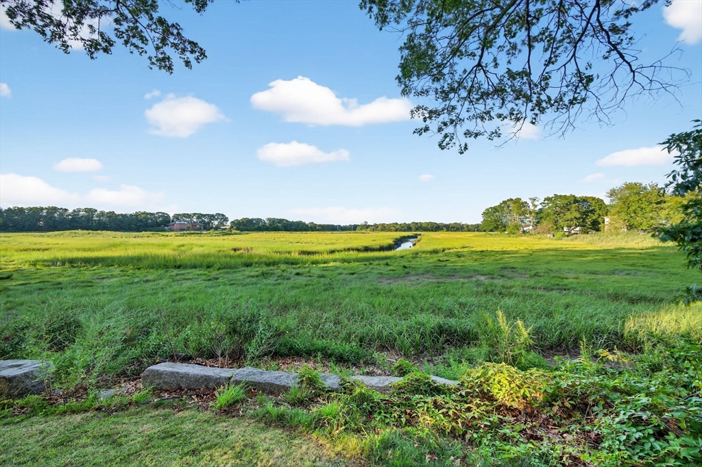 12 Quentin Street Milton, MA 02186 - Photo 6 of 41 a view of a golf course with a lake