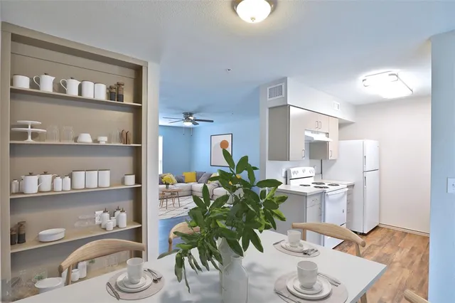 a dining room with furniture and wooden floor