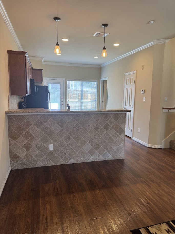 1198 Jones-Butler Road, Unit 1904 College Station, TX 77840 - Photo 2 of 17 Kitchen featuring crown molding, a peninsula, dark wood-type flooring, decorative light fixtures, and recessed lighting