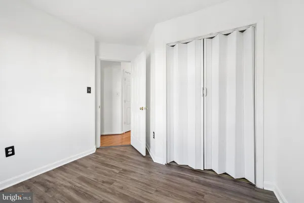 an empty room with wooden floor and a window