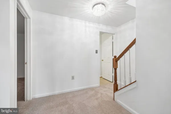 a view of an empty room with a fireplace