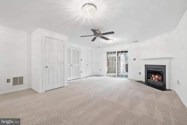a view of an empty room with a fireplace