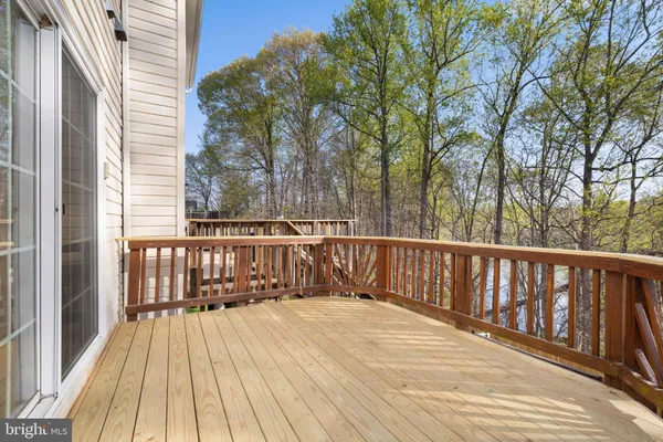 a view of a deck with wooden floor and fence