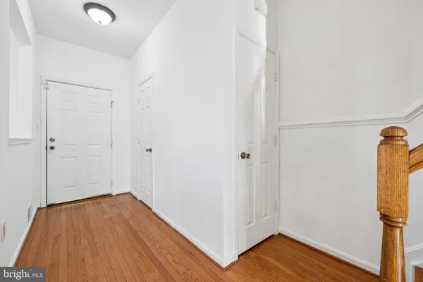 a view of empty room with wooden floor and fireplace