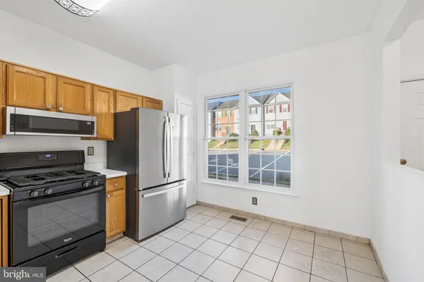 a kitchen with stainless steel appliances granite countertop a stove a refrigerator and a sink
