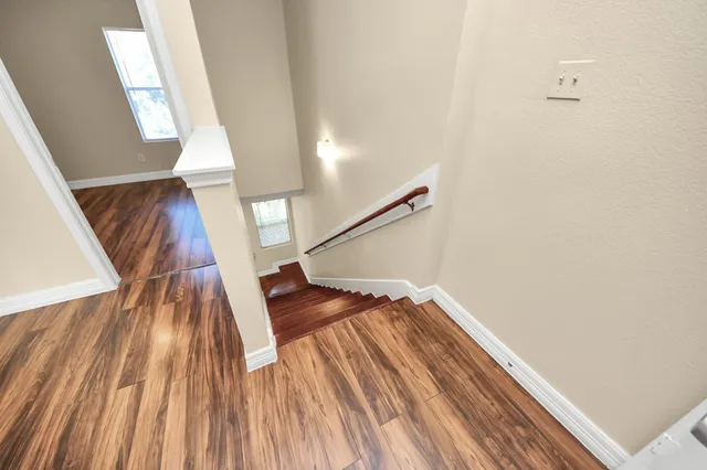 a view of an empty room with wooden floor