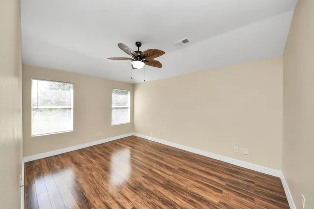 a view of an empty room and wooden floor