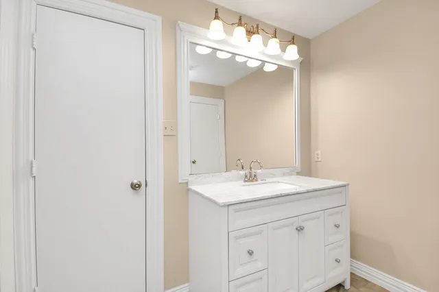 a bathroom with a glass shower door