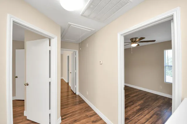 a view of a backyard with large trees