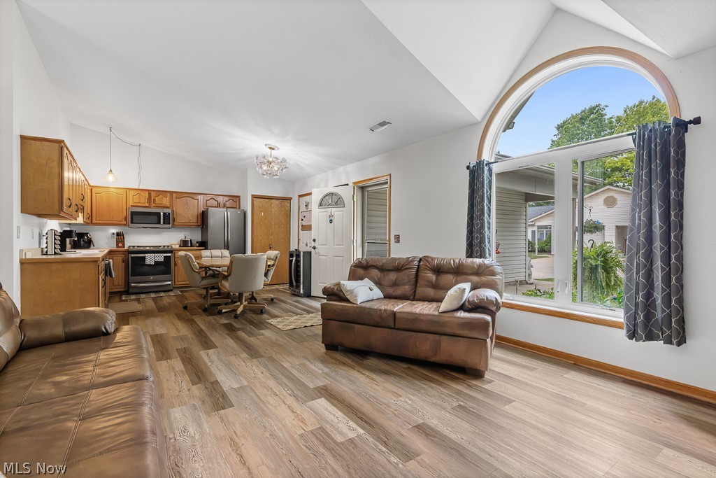 808 Ryan Road, Unit 14 Medina, OH 44256 - Photo 8 of 40 Vaulted ceilings enhance the open concept living area featuring wood-finish flooring