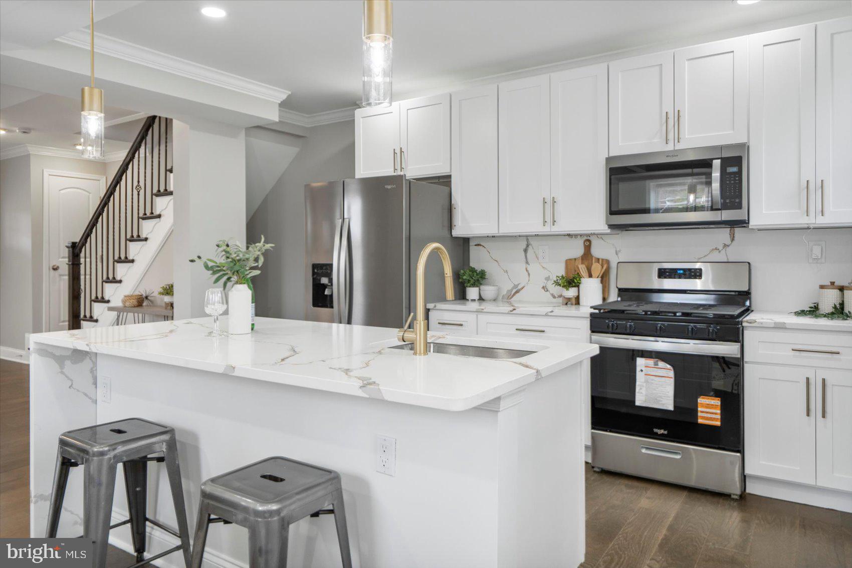2901 Edison Highway Baltimore, MD 21213 - Photo 13 of 52 a kitchen with stainless steel appliances a stove a sink a microwave and cabinets
